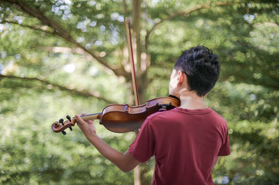 Rear view of man playing the outdoors