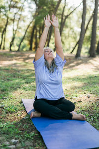 Young woman exercising on field