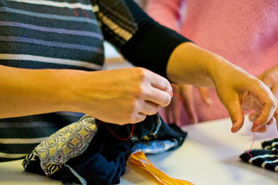 Midsection of woman sewing textile