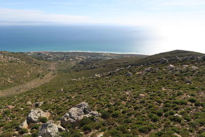 Scenic view of sea and mountains against sky