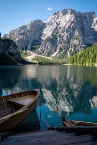 Rowboat moored at lake braies by rocky mountains