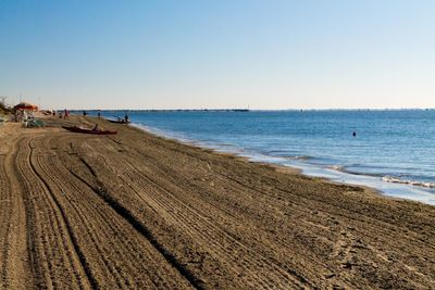 Scenic view of beach against clear sky