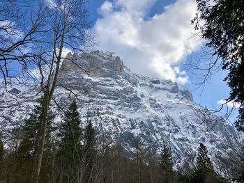 Low angle view of snowcapped mountains against sky