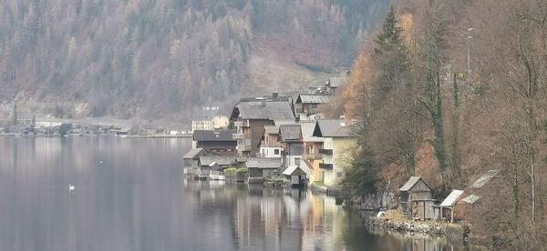 Panoramic view of lake and buildings against sky