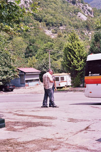 Rear view of man working on road