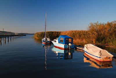 Boats moored in calm blue sea