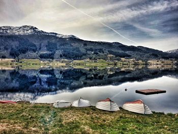 Scenic view of lake and mountains against sky