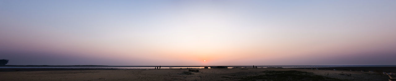 Scenic view of beach against sky during sunset