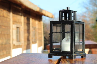 Lantern on table against building