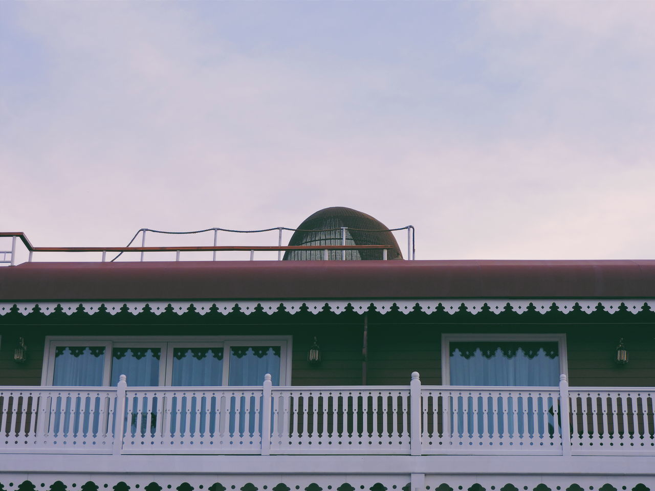 architecture, built structure, building exterior, low angle view, sky, roof, house, day, arch, outdoors, tree, exterior, residential building, no people, high section, building, facade, clear sky, residential structure, cloud - sky