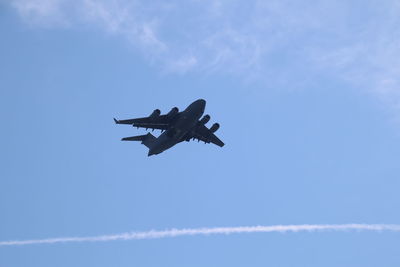 Low angle view of airplane flying in sky