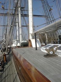 Sailboats moored at harbor against sky