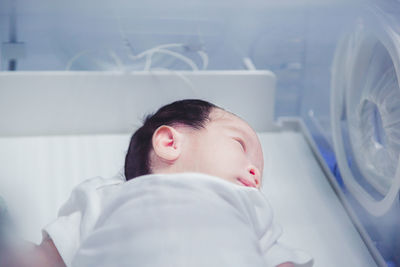 Portrait of cute boy sleeping in bed