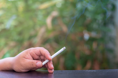 Hand holding cigarette