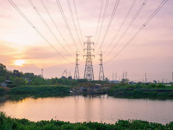 Scenic view of electricity pylon against sky during sunset