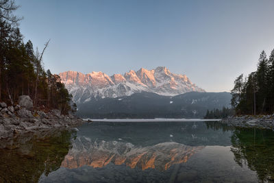 Scenic view of lake and mountains against clear sky