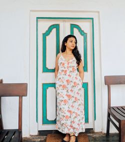 Portrait of woman standing against wall