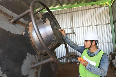 Mechanic engineer in factory checking quality of metals