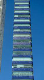 Low angle view of modern building against clear blue sky