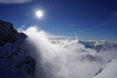 Low angle view of snow capped mountains against sky