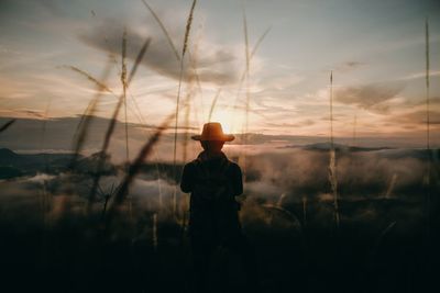 Lonely tourist looking at view at sunset