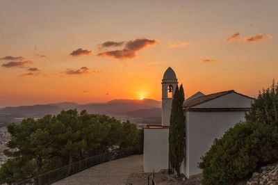 Scenic view of building against sky during sunset