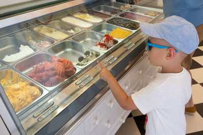 High angle view of boy standing on display