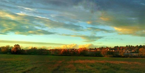 Scenic view of field against sky at sunset