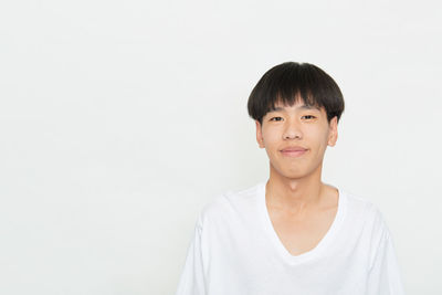 Portrait of smiling man against white background