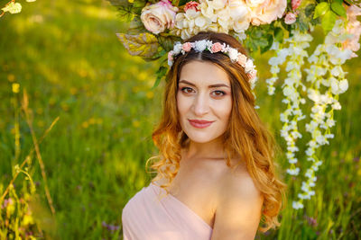 Portrait of beautiful young woman wearing flowers