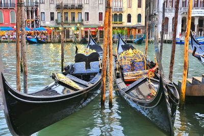 Boats moored on canal in city