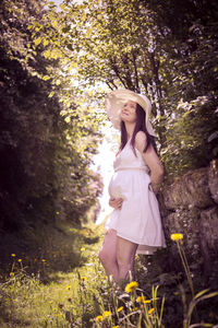 Woman standing by plants on land