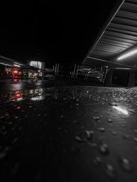 Surface level of wet road in city at night