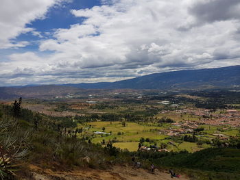 High angle view of field against cloudy sky