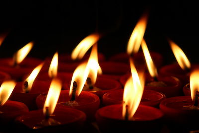 Close-up of lit candles in temple