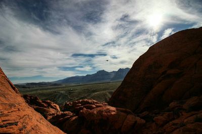 Scenic view of mountains against cloudy sky