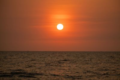 Scenic view of sea against orange sky