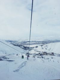 Ski lift over snow covered landscape