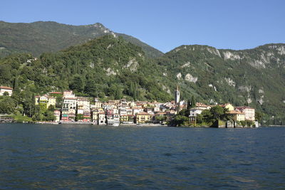 Scenic view of sea and buildings against sky