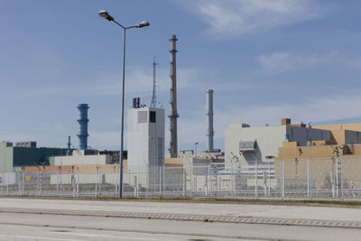 Low angle view of smoke stack against sky