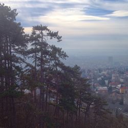 Cityscape against cloudy sky