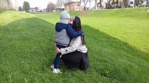 Rear view of man and woman on field