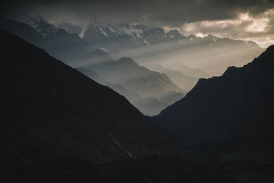 Scenic view of silhouette mountains against sky at dusk