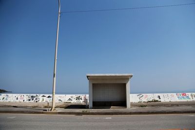 Road against clear blue sky