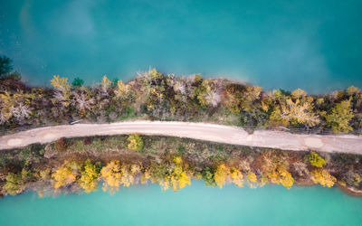 Aerial view of lakes devided by road and trees