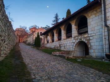 Arch bridge amidst buildings against sky