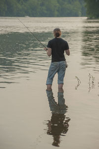 Full length of woman standing in lake