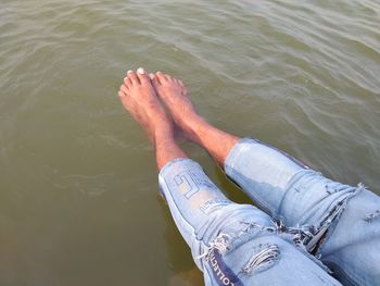 Low section of person legs in lake