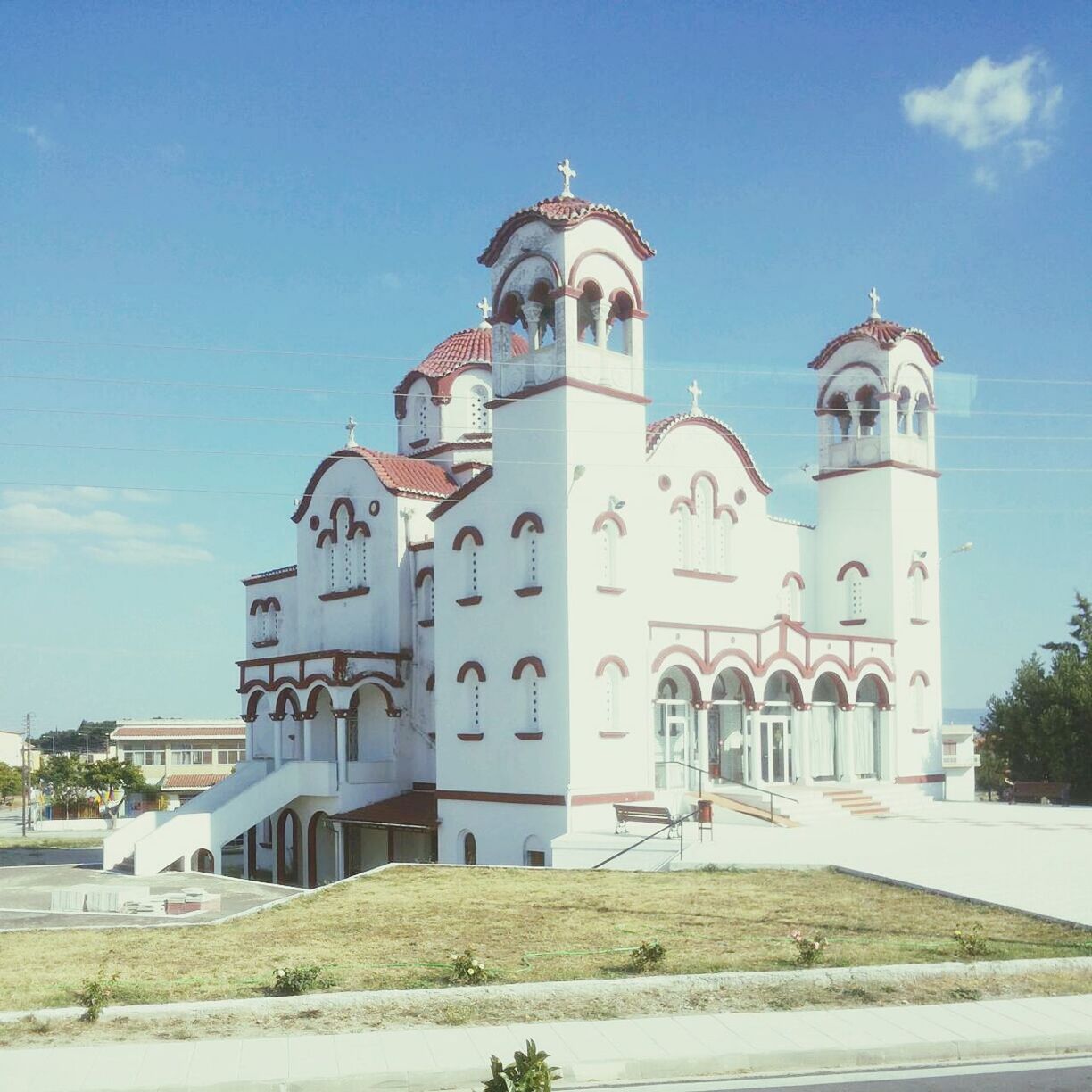 architecture, building exterior, built structure, church, sky, blue, religion, lighthouse, place of worship, protection, house, day, safety, sunlight, spirituality, low angle view, tree, no people