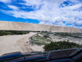 Road against sky seen through car windshield
